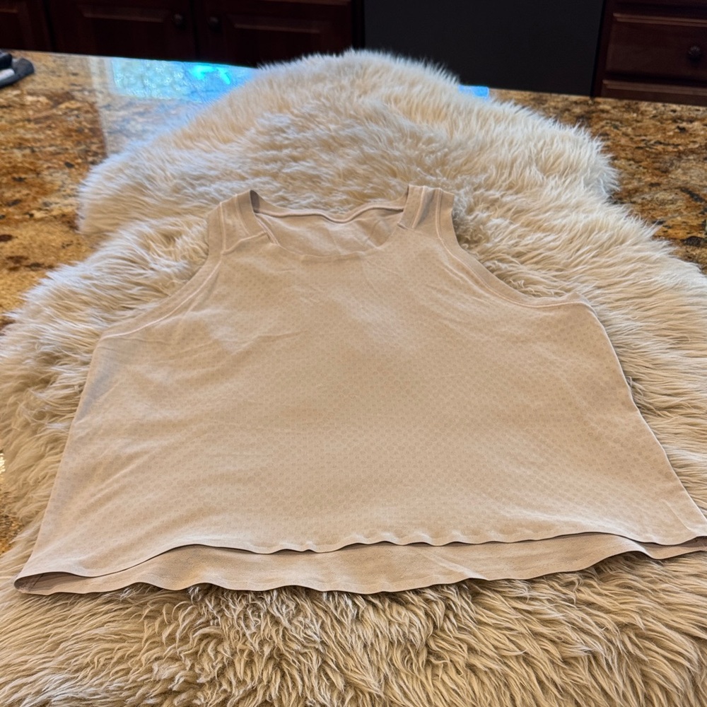 Lululemon tank top. Lightweight size 8 no tags. Beige color. Like new!